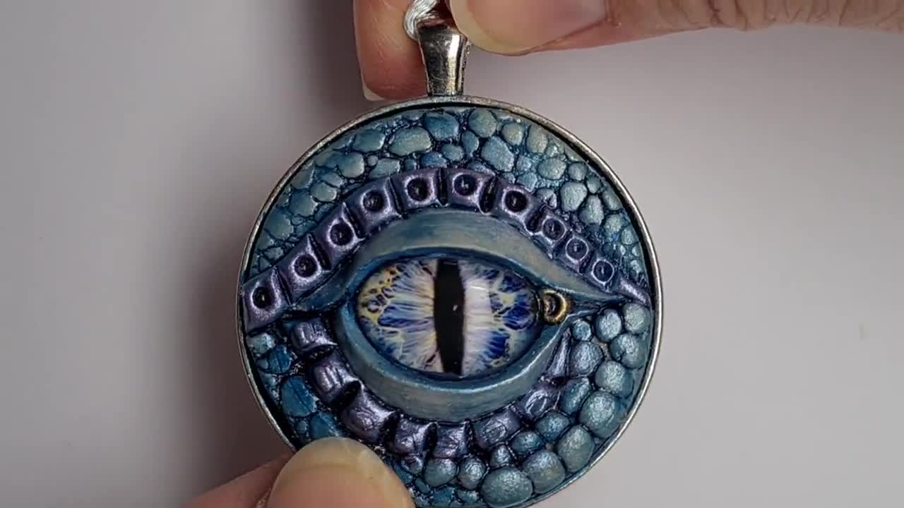 Polymer clay, glass dragon eye and raw crystal combined in…