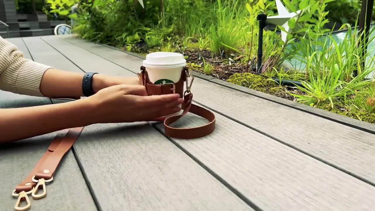 https://v.etsystatic.com/video/upload/q_auto/New_Coffee_Cup_Holder_and_Tumbler_Sleeve_with_Adjustable_Strap_-_for_both_hand_and_shoulder_carry_58_sec_o9hhor.jpg