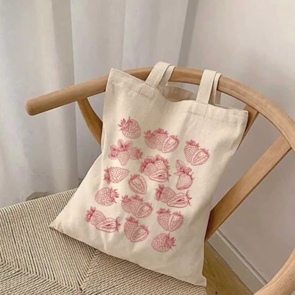 Hand offers Embroidered Reusable Produce Bag - Strawberries