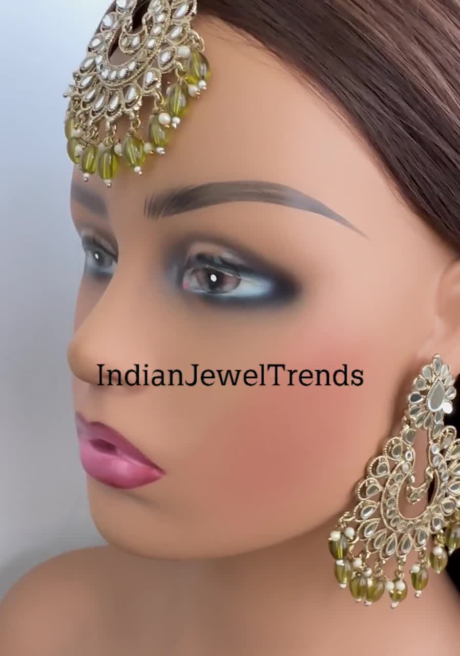 Photo of Large round maang tikka with large earrings and puff sleeves  metallic blouse