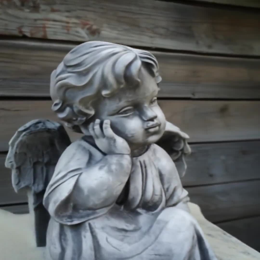 Pensive Baby Angel Statue: White Concrete Cherub, Lawn Ornament video poster