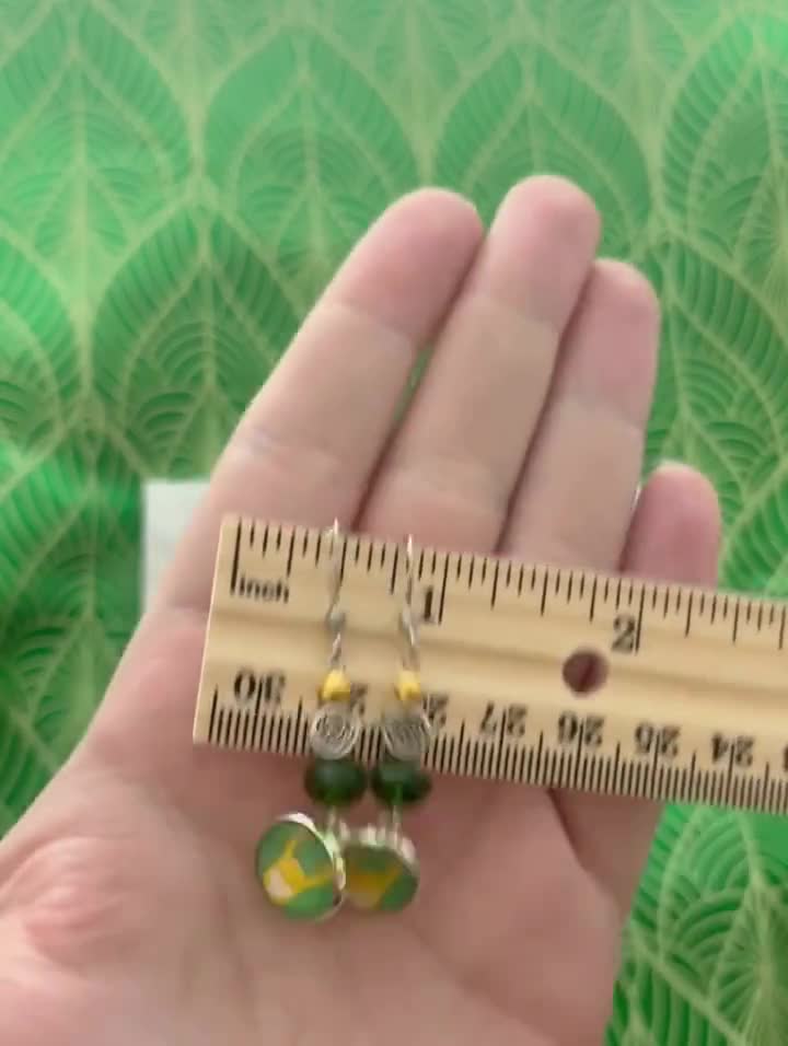 Green Loki Earrings - Handmade Art Charm Loki Helm Cabochon - Comic Inspired Jewelry - Silver Dangle Earrings - Loki Thor Geek Gift video poster