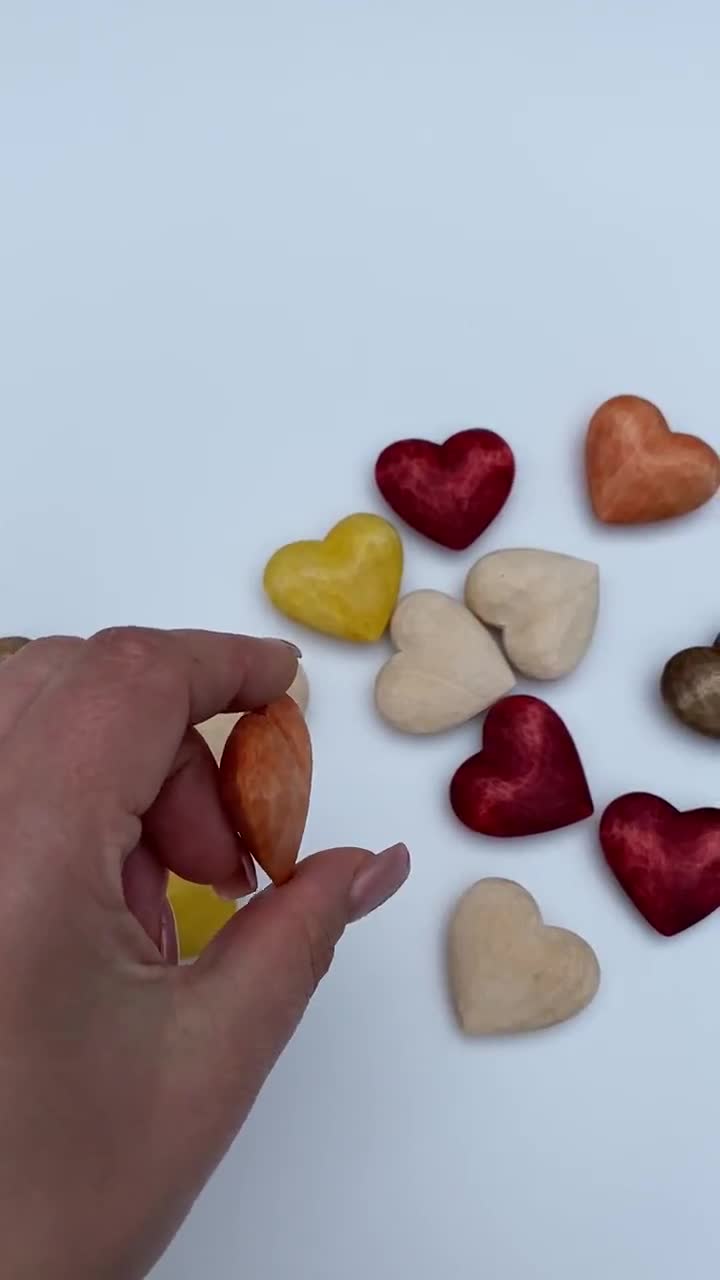 Carved small wooden hearts on table Stock Photo by ©stahov 144045503